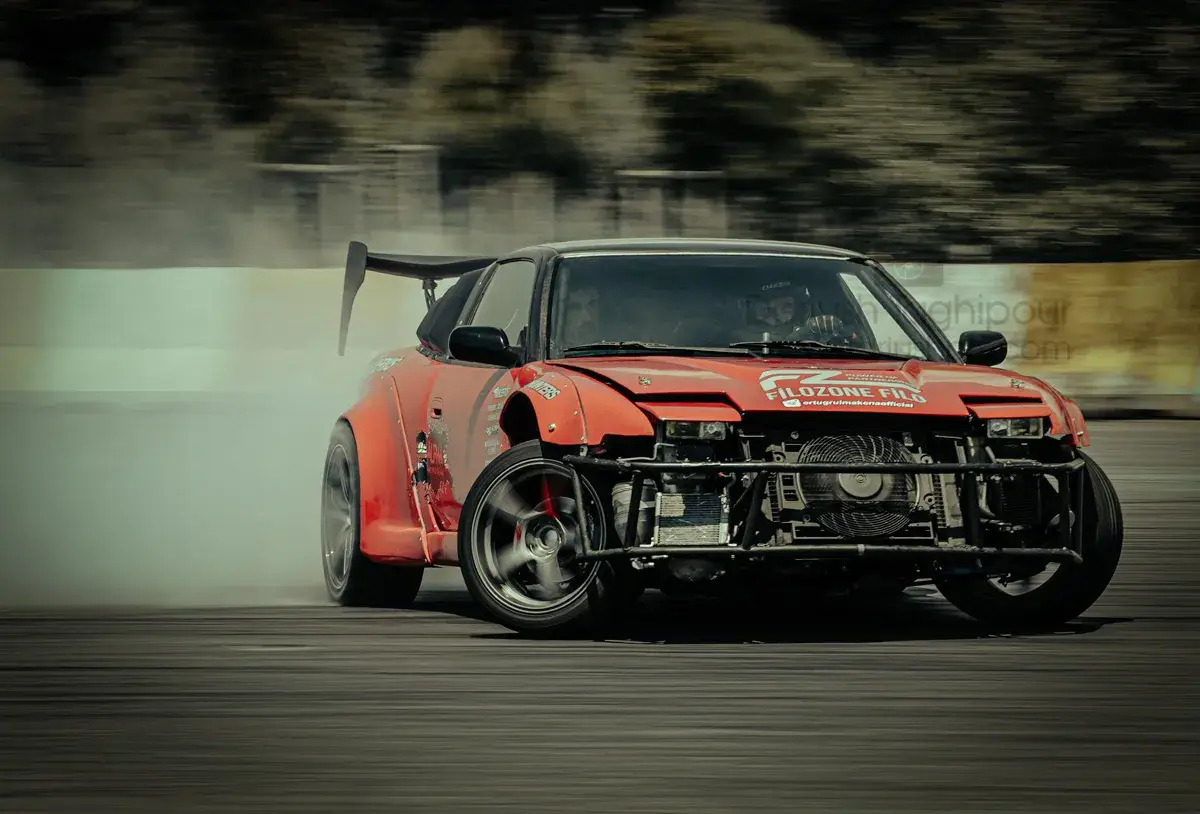 Experience the adrenaline of a red sport car drifting with precision. This high-resolution action shot captures perfect tire smoke, motion blur, and professional track techniques for automotive enthusiasts.